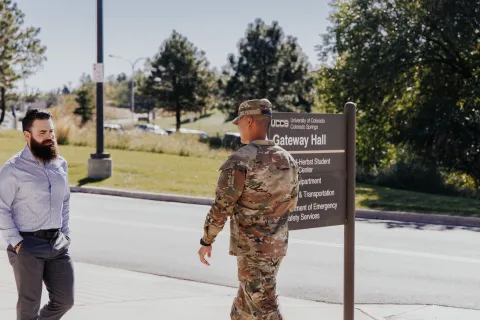 military student walking on campus in his uniform
